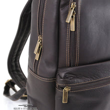 Load image into Gallery viewer, Angled side panel close up to the brown leather slim backpack. It features grass colored zipper pulls. 
