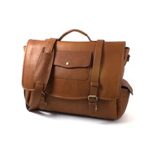 Load image into Gallery viewer, Angled front view of the tan leather briefcase with the shoulder strap resting on the front. 
