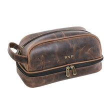 Load image into Gallery viewer, Angled front view of the brown leather toiletry bag. 
