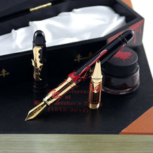Load image into Gallery viewer, Arrangement of the pen with the ink bottle, rollerball attachment, coffin, and book-shaped box.
