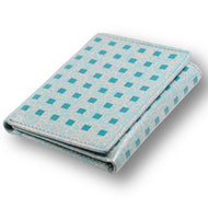 Angled view of the wallet. It is a light blue with a light orange design and a series of darker blue squares. Set on a white background.