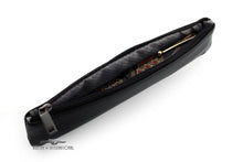 Load image into Gallery viewer, Angled view of the black leather pen case with a fountain pen inside. 
