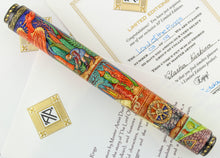 Load image into Gallery viewer, The pen placed on top of the certificates. This side shows a cart filled with fireworks, and a Hobbit lighting one of them.
