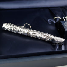 Load image into Gallery viewer, Side view of the fountain pen with the cap on placed on the presentation box. 
