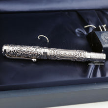 Load image into Gallery viewer, Side view of the fountain pen on the presentation box. The cap ring has an engraved .925 sterling silver hallmark.
