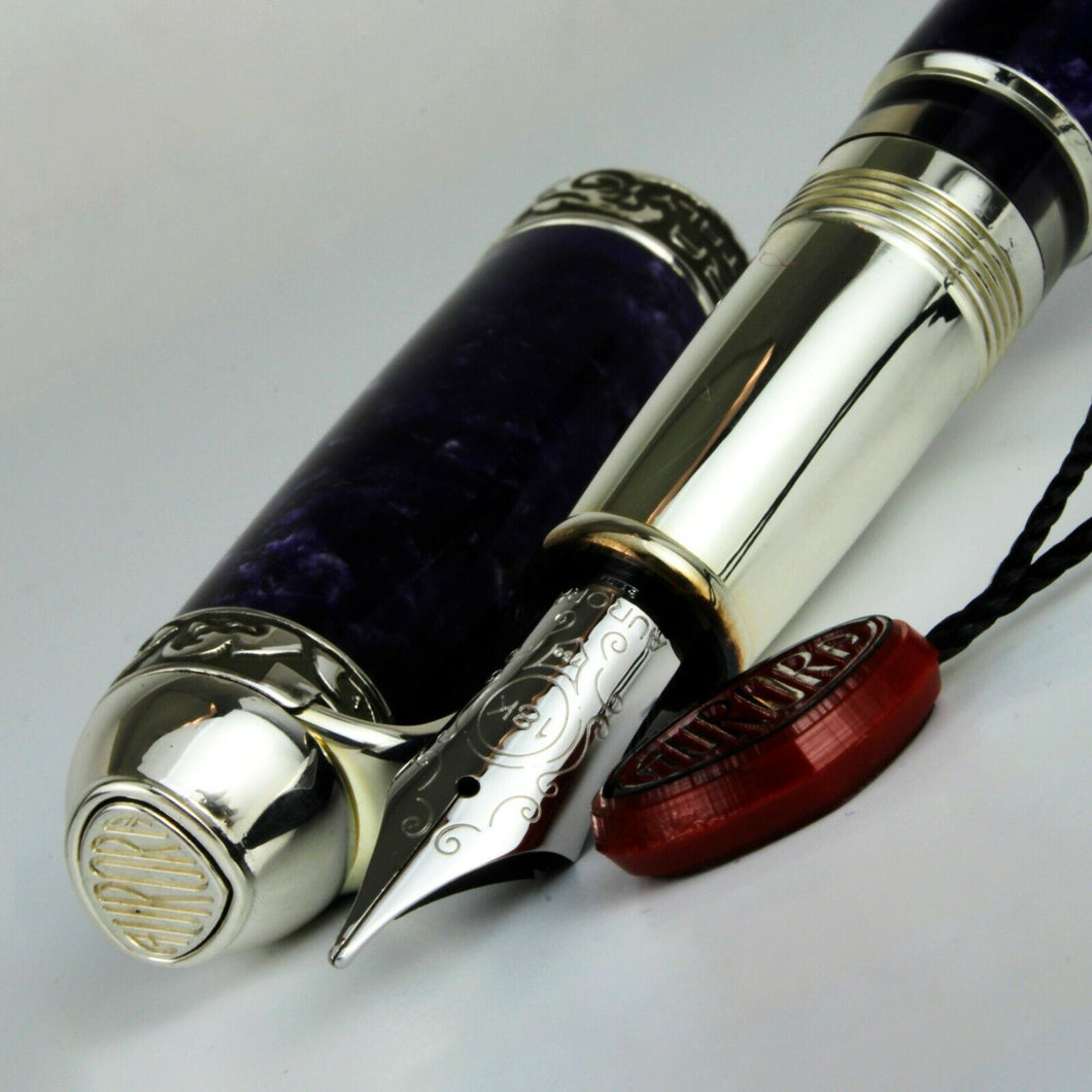 Close up to the Fountain Pen nib with the cap placed to the side. 