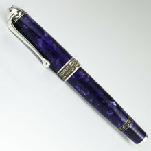 Load image into Gallery viewer, Side-view of the fountain pen on a white background. The pen features a purple marbled resin body with decorated silver accents. The cap ring reads &quot;AURORA MADE IN ITALY&quot; 
