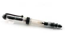 Load image into Gallery viewer, Front view of the Fountain Pen with the cap on. Set on a white background. The pen is transparent with black trims. 
