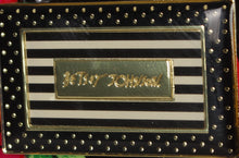 Load image into Gallery viewer, Close up to the decorated tag placed at the front of each suitcase. The Betsey Johnson logo is engraved at the center.
