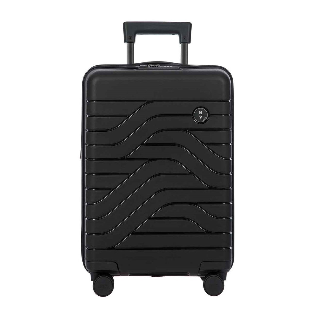 Front view of the black hard shell suitcase. The panel has a textured wave lines design, and a small black circular logo at the top right. The telescopic handle is partly pulled up.