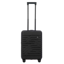 Load image into Gallery viewer, Front view of the black hard shell suitcase. The panel has a textured wave lines design, and a small black circular logo at the top right. The telescopic handle is pulled up.
