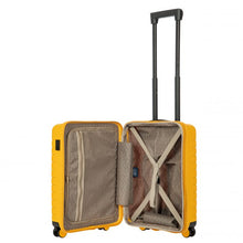 Load image into Gallery viewer, Interior view of the mango yellow hard shell suitcase with black accents. The fabric lining is light brown. The front panel&#39;s side has a zipper-closing compartment. The back panel&#39;s side has a set of strips to hold contents in place. 
