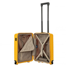 Load image into Gallery viewer, Interior view of the ligt blue hard shell suitcase with black accents. The fabric lining is light brown. The front panel&#39;s side has a zipper-closing compartment, shown partly opened. The back panel&#39;s side has a set of strips to hold contents in place. 
