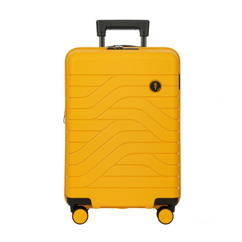 Front view of the mango yellow hard shell suitcase with black accents. The panel has a textured wave lines design, and a small black circular logo at the top right. The telescopic handle is pulled up.