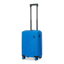 Load image into Gallery viewer, Angled front view of the electric blue hard shell suitcase with black accents. The front panel has a textured wave lines design, and a small black circular logo at the top right. The telescopic handle is pulled up.

