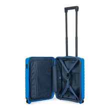 Load image into Gallery viewer, Interior view of the electric blue hard shell suitcase with black accents. The fabric lining is navy blue. The front panel&#39;s side has a zipper-closing compartment. The back panel&#39;s side has a set of straps to hold contents in place. 
