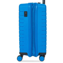 Load image into Gallery viewer, Side view of the electric blue hard shell suitcase with black accents. A USB port can be seen on the top left behind a hidden slide panel. 
