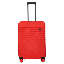 Load image into Gallery viewer, Front view of the red hard shell suitcase with black accents. The panel has a textured wave lines design, and a small black circular logo at the top right. The telescopic handle is pulled up.
