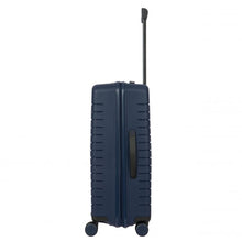 Load image into Gallery viewer, Side view of the navy blue hard shell suitcase with black accents. A black handle is placed for easy grabbing. 

