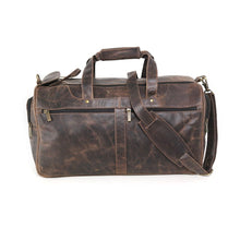 Load image into Gallery viewer, Front view of the brown distressed leather duffle bag. The shoulder strap is attached on the right hook and slid across the center.

