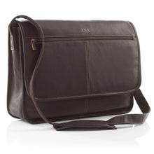 Load image into Gallery viewer, Angled front view of the brown leather messenger bag. The shoulder strap is resting at the front. 
