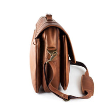 Load image into Gallery viewer, Side view of the tan leather briefcase. The shoulder strap is set toward the front panel. 
