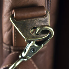 Load image into Gallery viewer, Close up to the brass clip attachment for the shoulder strap.
