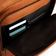 Load image into Gallery viewer, Angled close up to the opened front pocket. A cellphone, one pen, and a credit card are tucked in the dedicated compartments.

