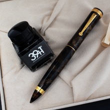 Load image into Gallery viewer, The fountain pen and ink bottle arranged inside of the presentation box.

