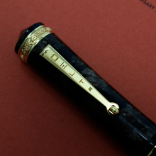 Load image into Gallery viewer, Close up to the cap's clip. It has the stylized engraving of the word DELTA.
