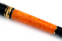 Load image into Gallery viewer, Close up to the orange pen body with engraved Delta logo and text: COLOSSEVM DIAMOND CELEBRATION 11 18 ITALY
