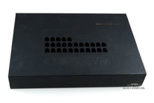 Load image into Gallery viewer, Angled view of the black card stock dust sleeve with a Colosseum cutout design on the top.
