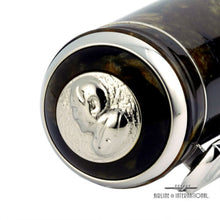 Load image into Gallery viewer, Angled close up to the silver disk with a profile portrait of Enrico Caruso engraved on it. 
