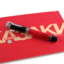 Load image into Gallery viewer, Angled view of the fountain pen with the cap on. Set on top of the red presentation box lid. 
