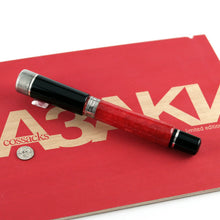 Load image into Gallery viewer, Angled back view of the fountain pen with the cap on. Set on top of the red presentation box lid.

