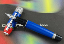 Load image into Gallery viewer, Front view of the fountain pen with the nib resting on the cap. 
