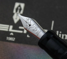 Load image into Gallery viewer, Close up to the fountain pen nib. It has an engraved reindeer horn and text: DELTA, 18KT-750
