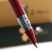 Load image into Gallery viewer, Close up to the grip section's silver band on the red pen.
