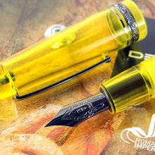 Load image into Gallery viewer, Angled close up to the fountain pen nib with the cap next to it.
