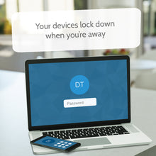 Load image into Gallery viewer, A laptop and cellphone on a table with a blurry background. The text reads: Your devices lock down when you're away.

