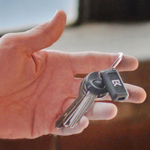 Load image into Gallery viewer, A hand holding a set of keys with the Everykey attach to the keyring.
