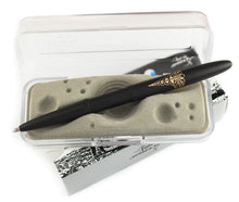 Load image into Gallery viewer, The matte black Caduceus pen with the cap posted, arranged with the packaging. 
