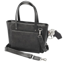 Load image into Gallery viewer, Angled front view of the black leather concealed bag. A pistol is peeking from the compartment.
