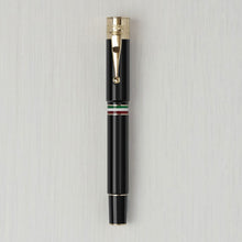 Load image into Gallery viewer, Front view of the black and gold pen with the cap on.
