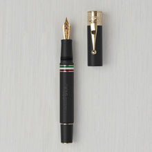 Load image into Gallery viewer, Front view of the matte black fountain pen with golden trims. The cap is set next to it. 
