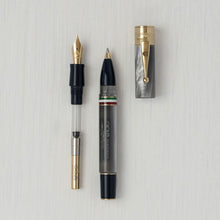 Load image into Gallery viewer, The marble gray with golden trims ballpoint pen with the cap and fountain pen housing unit set to the sides.
