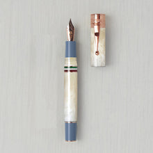 Load image into Gallery viewer, Front view of the ivory fountain pen with the cap next to it. 
