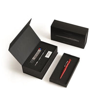 Load image into Gallery viewer, The red ballpoint pencil pen arranged with its included packaging and contents on a white background. 
