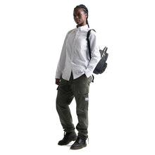 Load image into Gallery viewer, A young woman carrying the black Nova Mini backpack on her left shoulder. 
