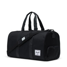 Load image into Gallery viewer, Angled front view of the black duffle bag. 
